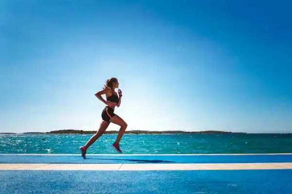 Woman running showing strong leg muscle Norwich